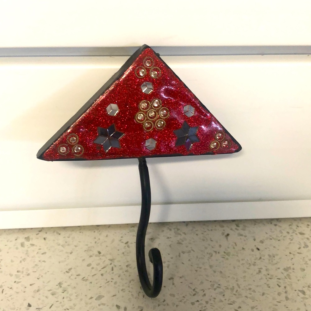 Beautiful, decorative mirrored wall hook. 5.5” long. Originally from India.